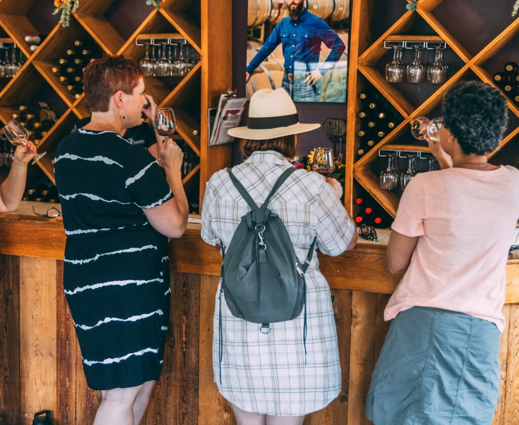 people sipping on wine at a counter at Augusta Winery