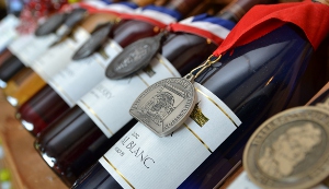 a row of wine bottles from Augusta Winery with medals hanging on the necks